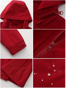 Detail view of waterproof red hooded jacket showing zipper, cuffs, and water-repellent fabric