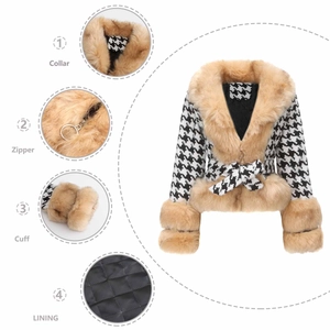 Detail view of houndstooth jacket showing faux fur collar, zipper, and quilted lining