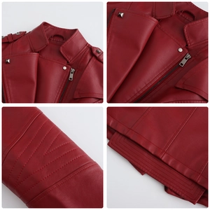 Detail view of burgundy leather jacket featuring silver zippers and metal rivet accents