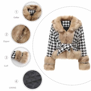 Detail view of houndstooth jacket showing faux fur collar, zipper, cuff and quilted lining