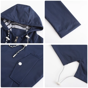 Detail of waterproof jacket with striped hood lining, drawstrings and button pockets