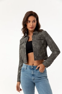 Detail of grey suede jacket featuring utility pockets and metallic front buttons