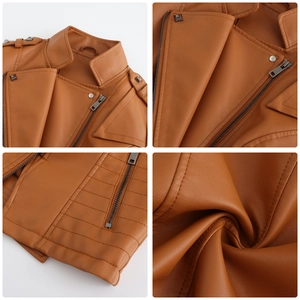 Detail of brown leather biker jacket showing rivets, metal zipper and textured fabric