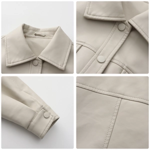 Detail view of beige PU leather jacket with lapel collar, buttons and fine stitching