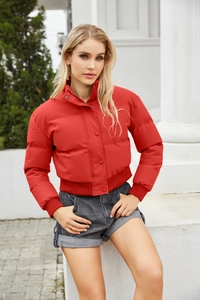 Detail of red padded jacket featuring a stand collar and ribbed cuffs for wind protection