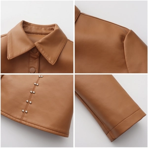 Macro detail of brown leather jacket collar, stitching, and metal rivet embellishments