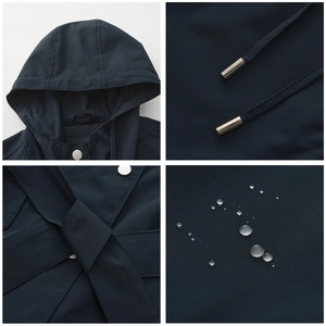 Detail view of water-resistant navy hood jacket with metal snap buttons and drawstrings