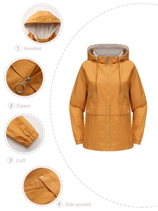 Detail view of ginger yellow hooded windbreaker showing zipper, cuffs and side pockets