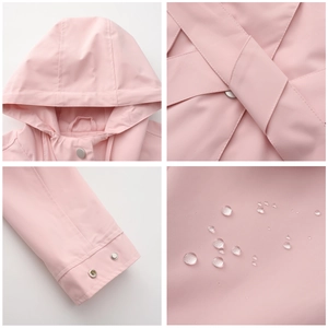 Detail of hooded waterproof pink jacket showing cuffs and water-repellent fabric texture