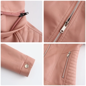Detail view of pink faux leather jacket featuring metal zippers, snaps, and quilted seams