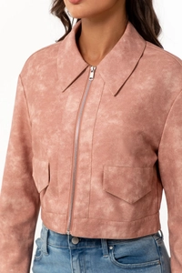 Detail of faux suede texture on pink slim jacket with lapel and decorative flap pockets