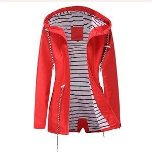 Detail of red hooded raincoat featuring black and white striped lining and drawstring