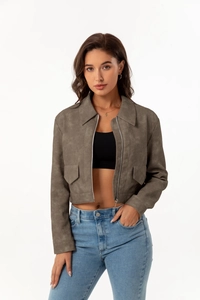 Detail of grey cropped faux suede jacket with chest pockets and metal zipper closure
