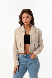 Detail of light beige faux leather jacket with zip closure and lapel collar