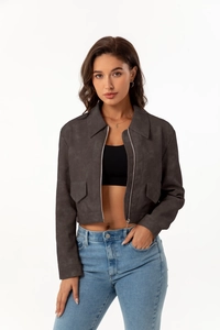 Detail of grey suede cropped jacket with metal zipper and symmetrical chest pockets