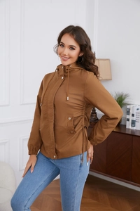 Detail of brown hooded windbreaker featuring functional waist drawstring and metal snaps