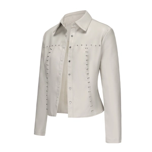 Close-up of cream PU leather jacket with silver studs and metal snap buttons