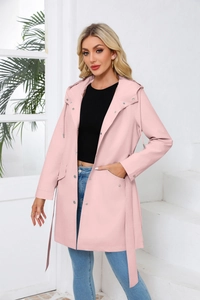 Detail of a pink hooded mid-length trench coat with snap buttons and drawstring waist