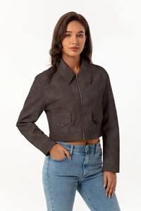 Detail of a charcoal faux suede jacket featuring metal zippers and flap chest pockets