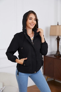 Close-up of black hooded windbreaker with adjustable drawstrings and metallic snap buttons