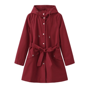 Detail of burgundy hooded raincoat with white snap buttons and adjustable waist tie