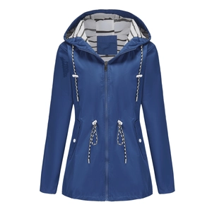 Detail view of water-resistant long raincoat featuring striped lining and drawstring waist