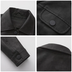 Detail view of black faux leather jacket showing collar, pockets and matte snap buttons