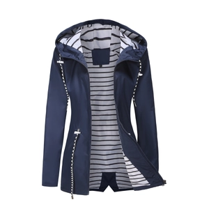 Detail of navy hooded raincoat featuring striped lining and white adjustable drawstrings