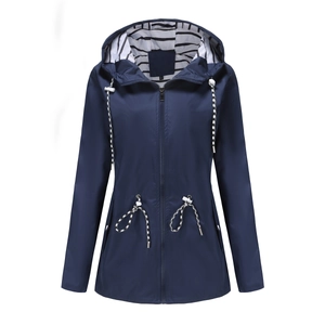 Detail view of navy blue hooded trench coat with striped lining and adjustable drawstring
