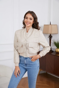 Detail of off-white faux suede jacket with snap buttons and ribbed cuffs on sleeve