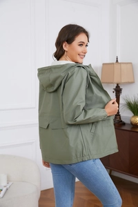 Detail showing army green hooded windbreaker jacket with drawstring and elastic cuffs