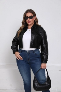 Close-up of black faux leather jacket featuring metal buttons and dual flap pockets