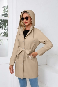 Close-up of beige waterproof hooded trench coat with metal buttons and waist belt