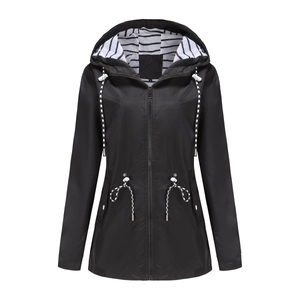Detail of waterproof hood with striped lining and adjustable drawstrings on black raincoat