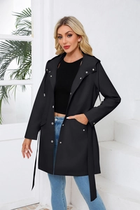 Detail of hooded waterproof trench coat featuring silver snaps and waist tie closure