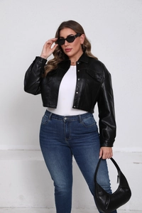 Detail of matte black PU leather jacket with silver buttons and front flap pockets
