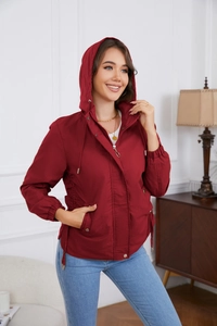 Detail of burgundy windproof hooded jacket with waist drawstring and zipper closure