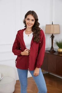Detail of burgundy windbreaker jacket with adjustable drawstring hood and metal zipper closure