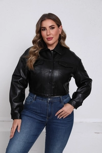 Close-up of black faux leather jacket featuring classic lapels and snap button details