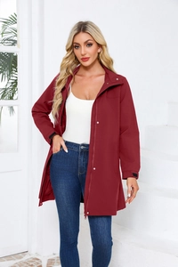 Detail view of burgundy windbreaker jacket with adjustable Velcro cuffs and hood
