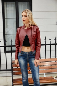 Detail view of burgundy faux leather jacket with ribbed sleeve quilting and zipped pockets