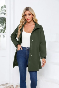 Detail showing the olive green water-resistant jacket with hood and adjustable cuffs