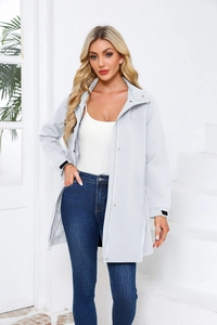 Detail view of water-resistant light gray long trench coat with adjustable cuffs and hood