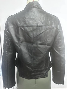 Detail view of the back seams and quilted sleeve design on a black faux leather jacket