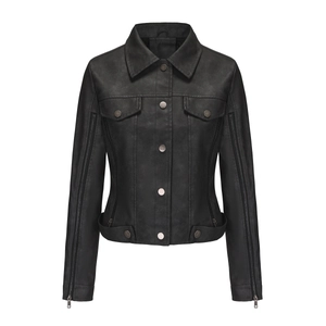 Detail of a black faux leather motorcycle jacket with decorative zipper sleeves and pockets