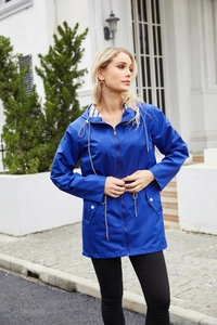 Detail showing deep blue raincoat with striped lining and white drawstring adjustment