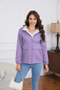 Detailed shot of purple hooded windbreaker with metal zipper rings and large utility pockets