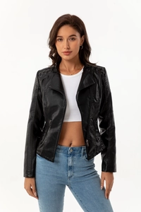 Detail of shoulder quilted stitching and metal eyelets on a black PU moto jacket