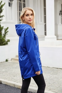 Close-up of royal blue hooded raincoat featuring striped lining and adjustable drawstring