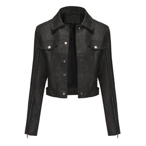 Detail of a black faux leather biker jacket featuring silver zippers and matte texture